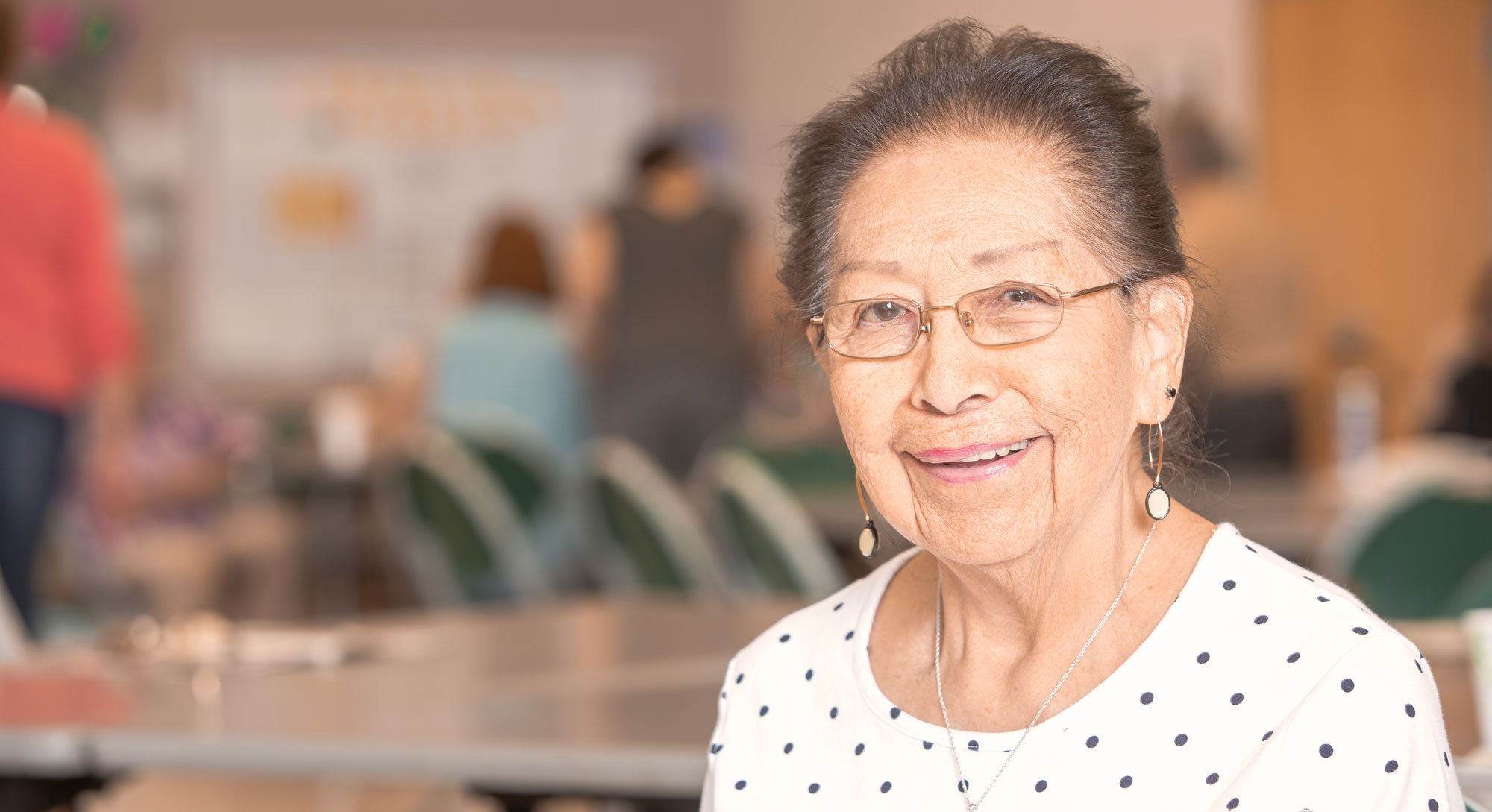 Smiling senior woman on blurred background