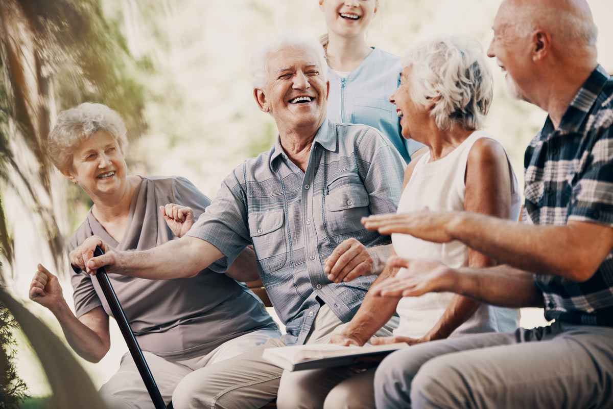 Seniors Sitting Outside Laughing at Kelowna VRS Retirement Community
